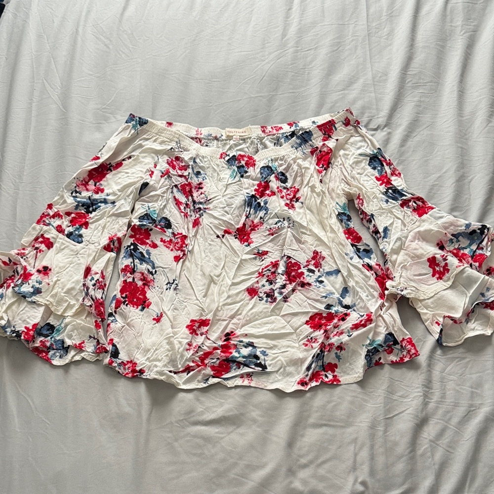 White shirt with floral bell sleeves. Shoulder-less.